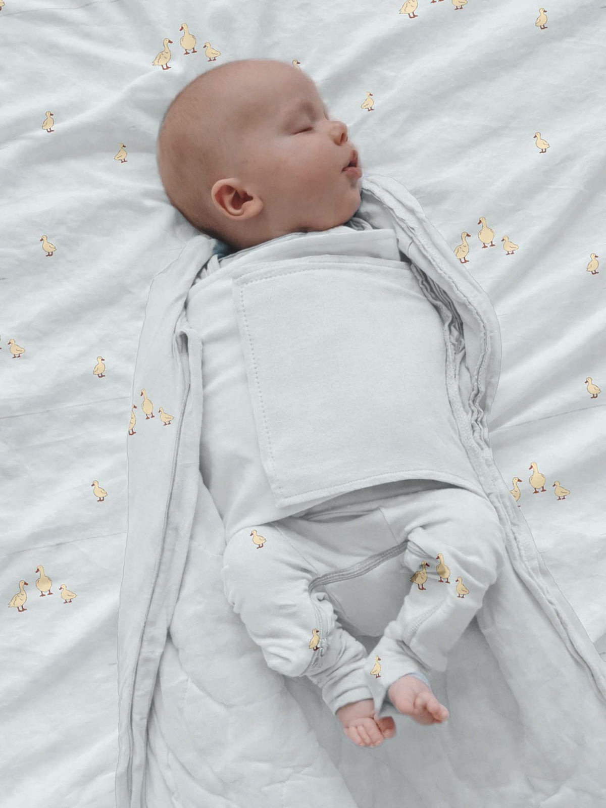 Swaddle sleep sack with duck print, open zip and fold-over design, light gray