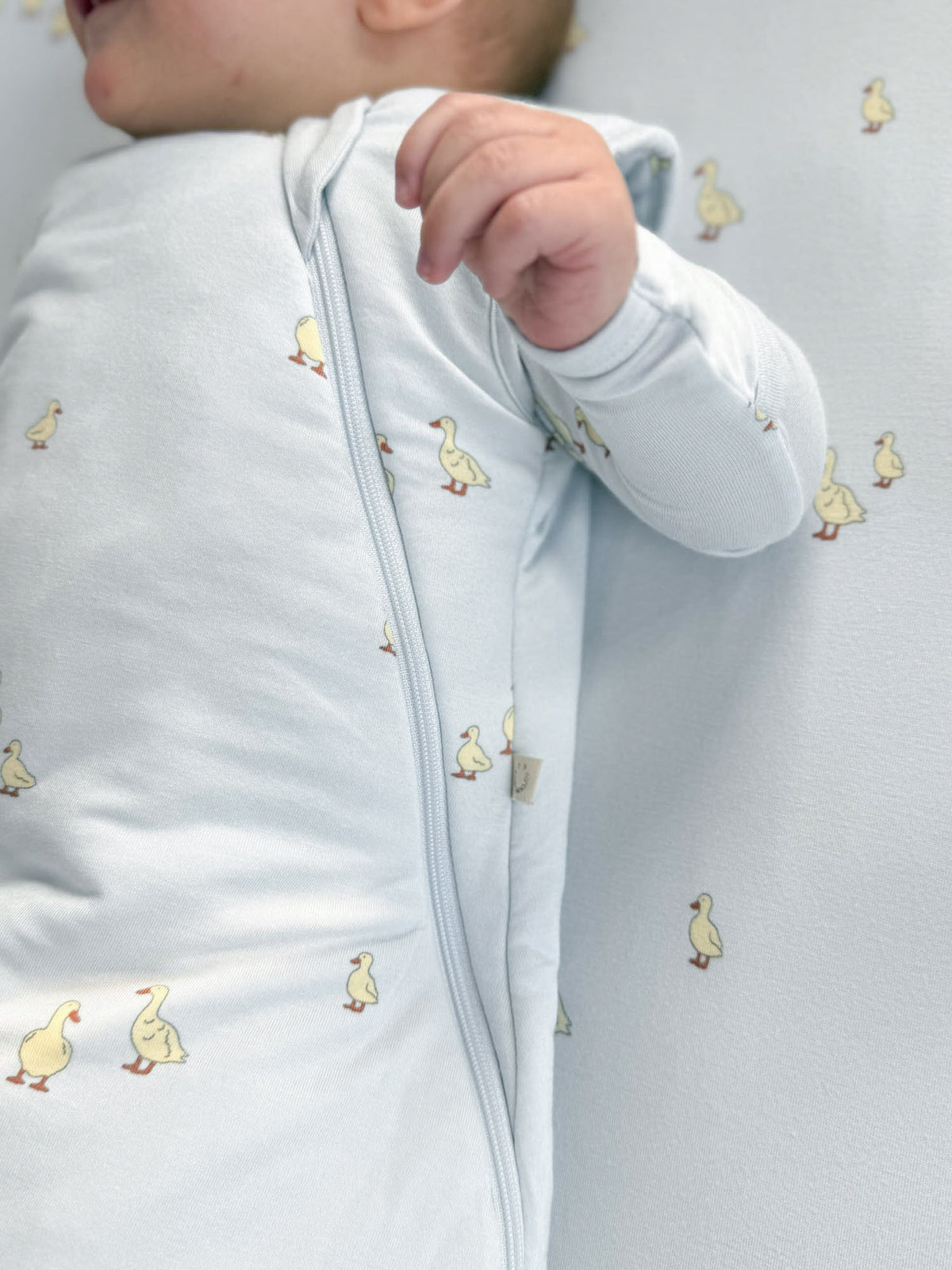 Transitional swaddle sleep sack, light blue duck print, front zip opening