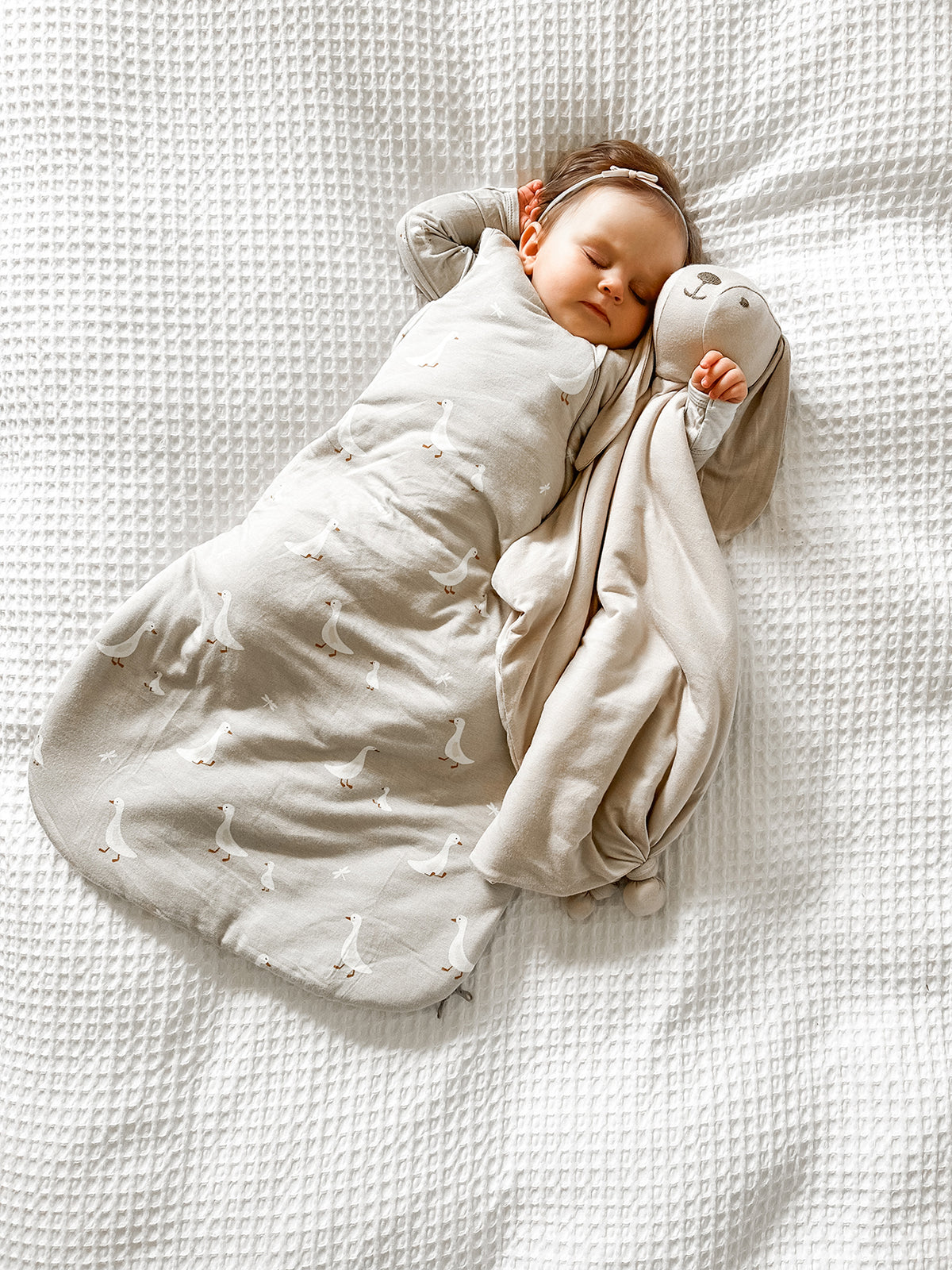 Cream swaddle sleep sack with white goose print and attached swaddle wings