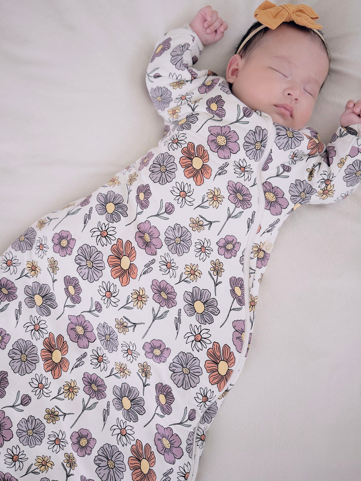 Floral long sleeve swaddle sack with head opening, suited for cozy transitional use