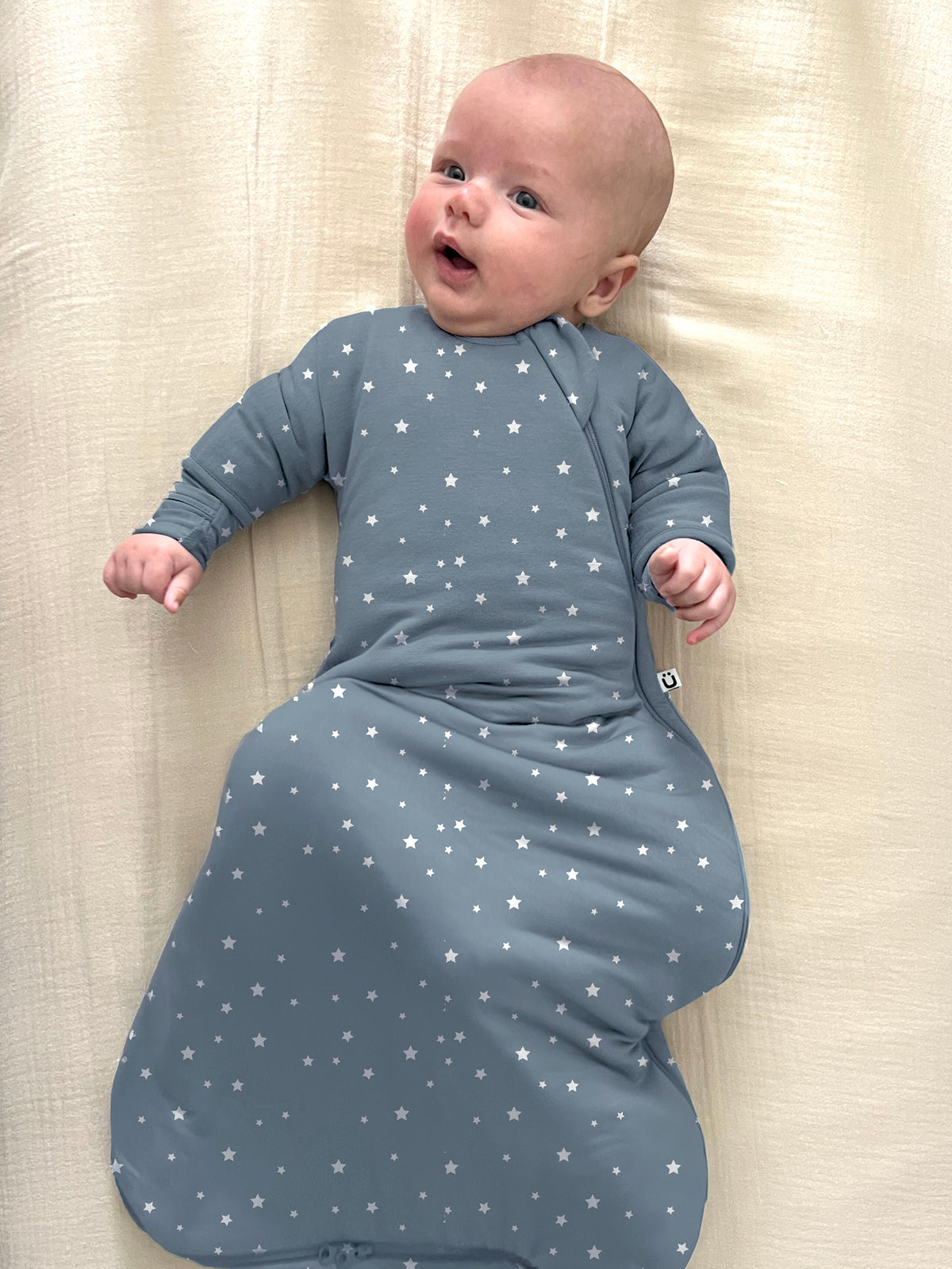 Long-sleeve swaddle sack in blue with white stars; baggy swaddle shape