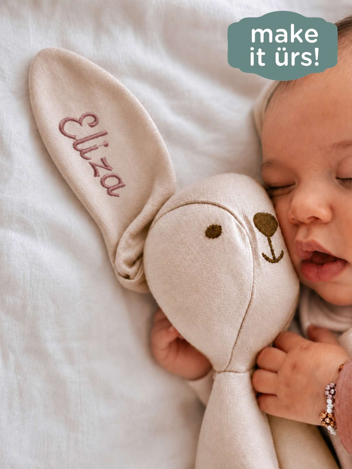 Beige bunny lovey with embroidered 'Lucy' on ear and stitched smiling face