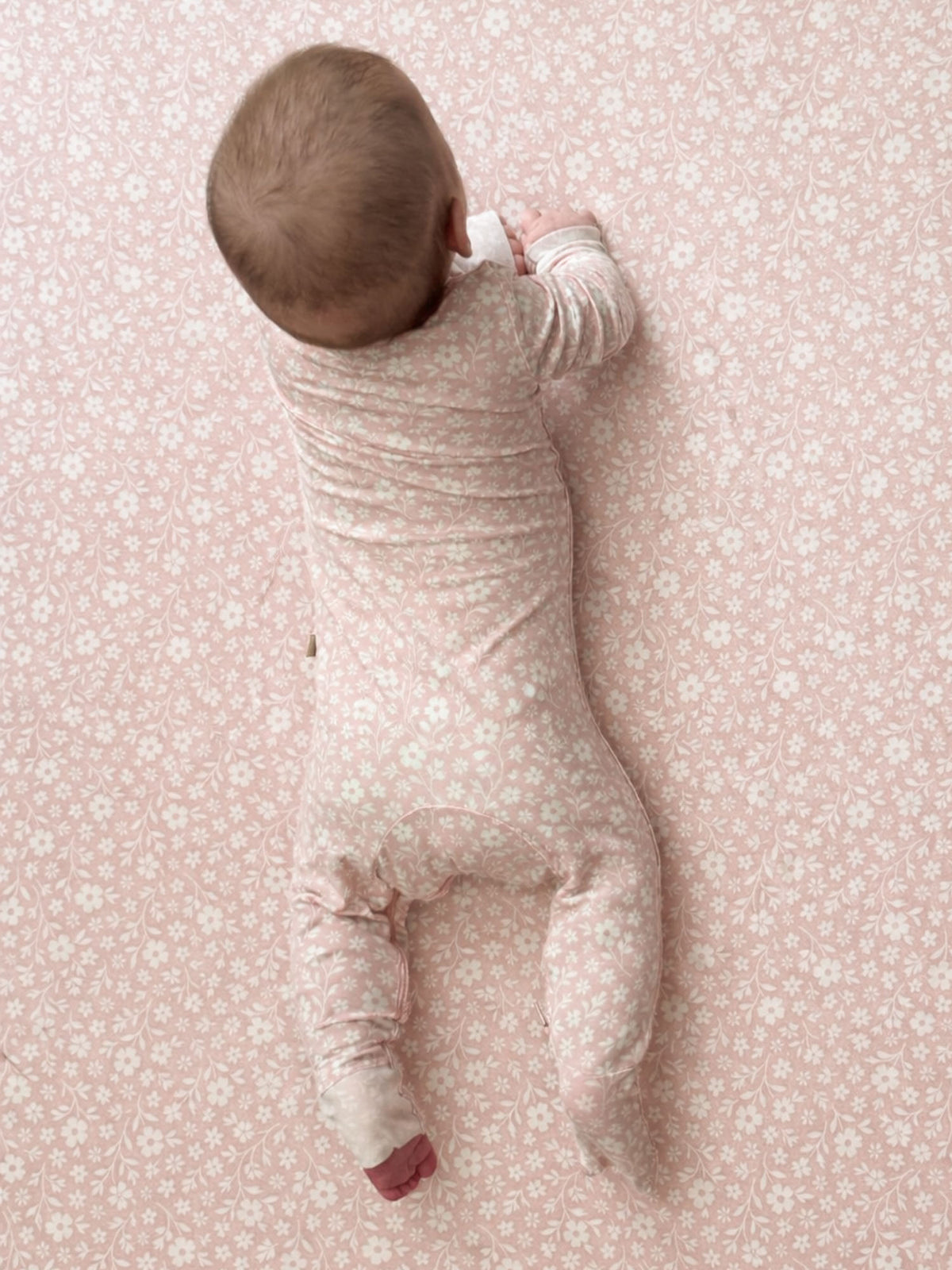 Blush pink floral convertible pajama sleeper with long sleeves and foldover legs