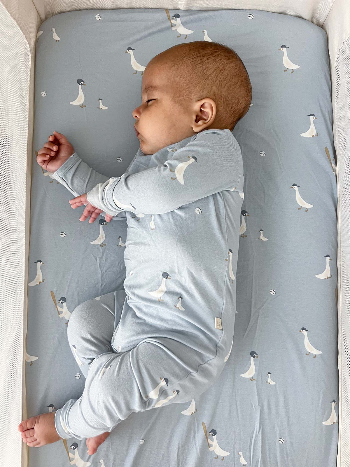 Light blue goose-print convertible baby pajama with long sleeves and footed legs
