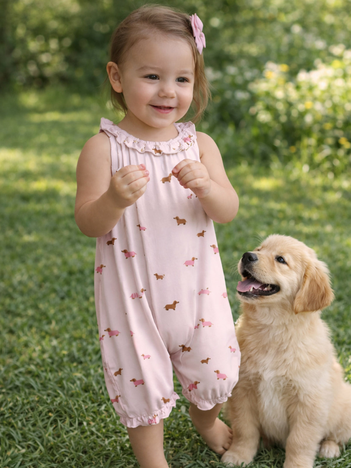 Girls' pink dog-print bubble romper with ruffled neckline and gathered legs