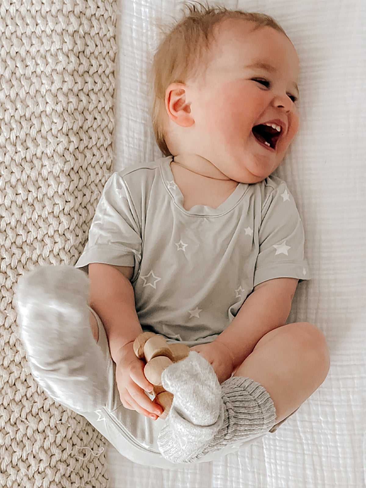 Sage gray shortie romper with white stars, short sleeves and comfortable short legs