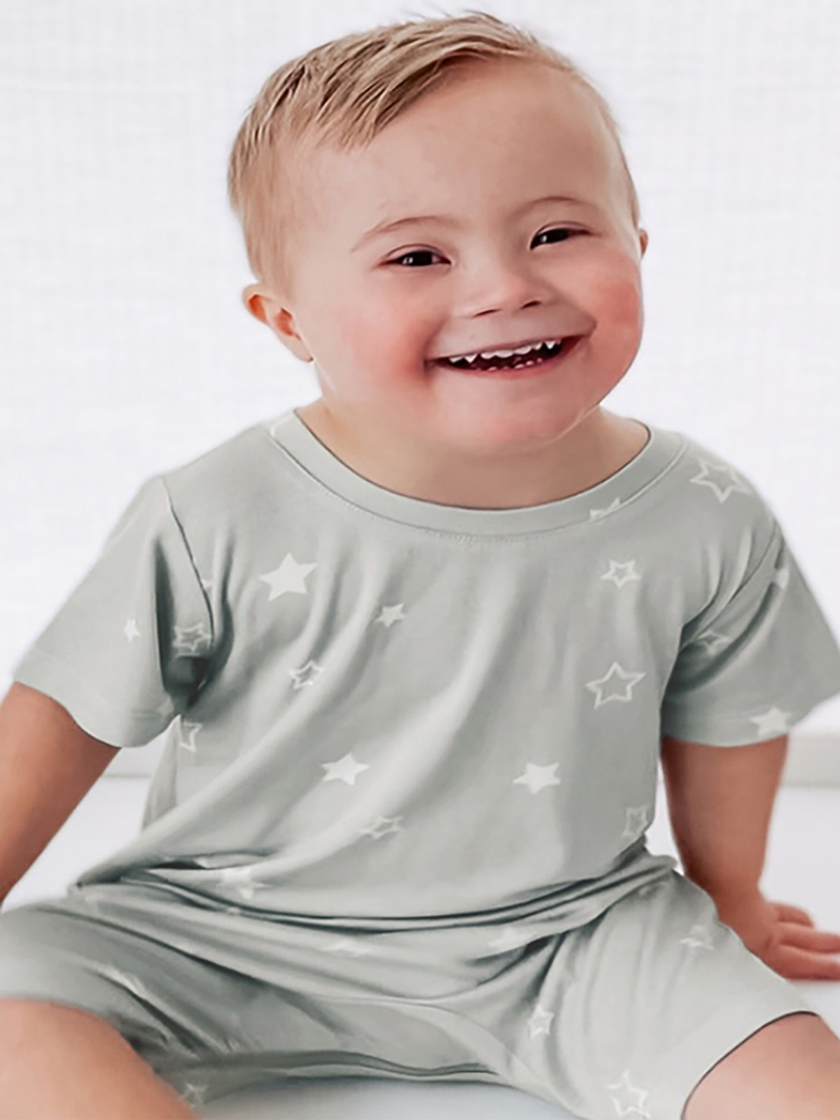 Sage gray shortie romper with allover white star print, short sleeves and legs