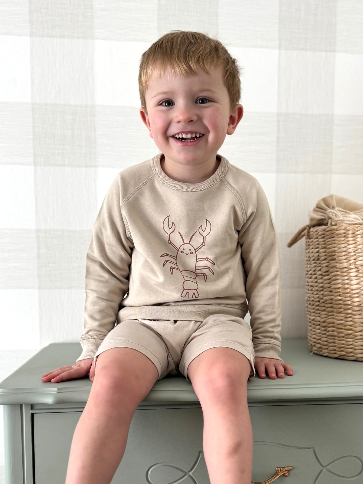 Beige crewneck sweatshirt with long sleeves and lobster graphic in rust orange