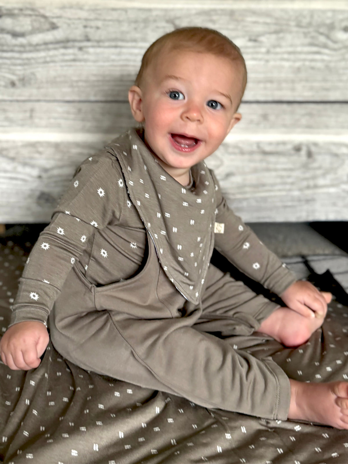 Fleece overall romper in taupe with white dot pattern and long sleeves