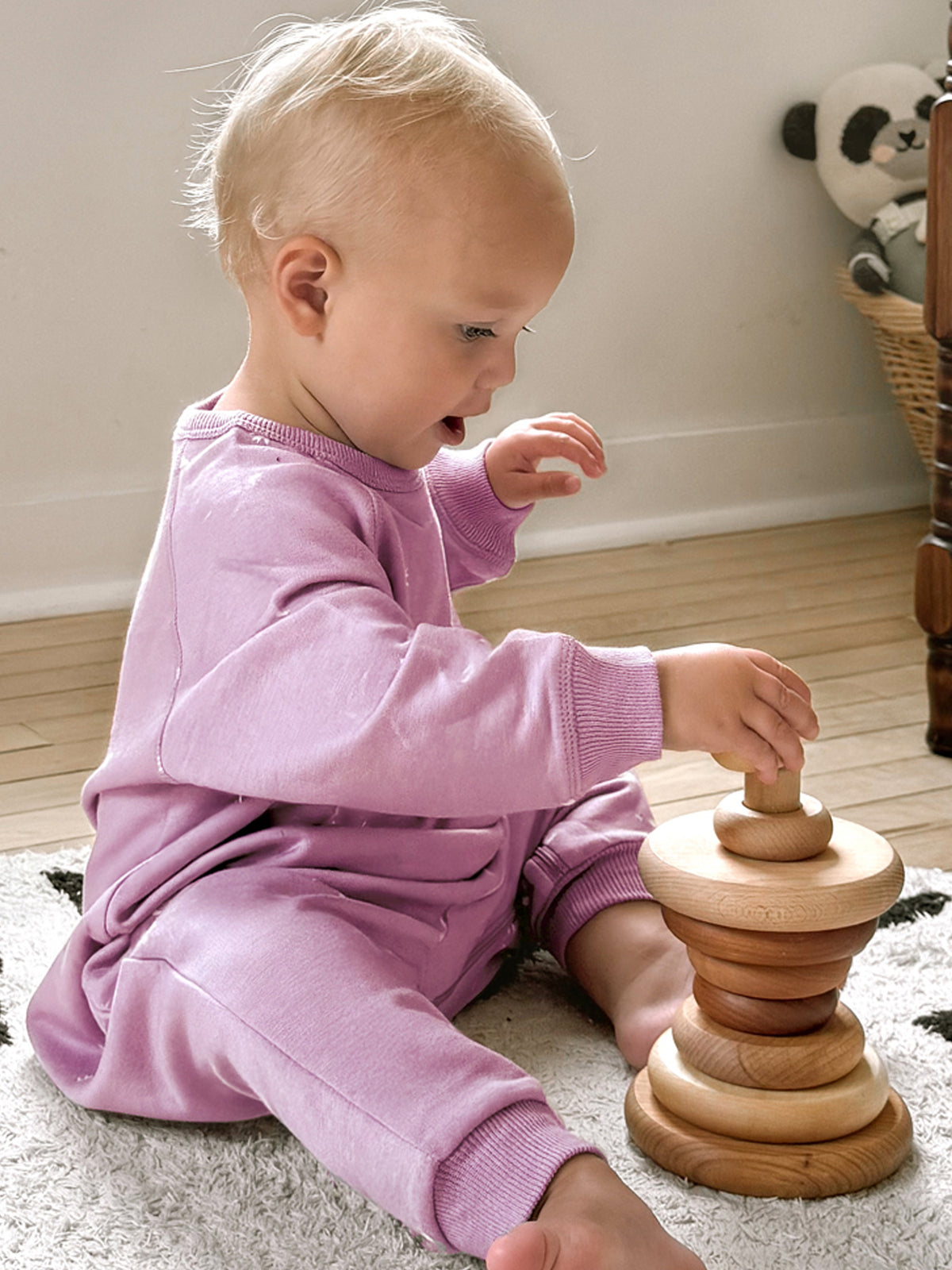 Lilac long-sleeve cotton jumpsuit on toddler sitting, ribbed cuffs and smooth front