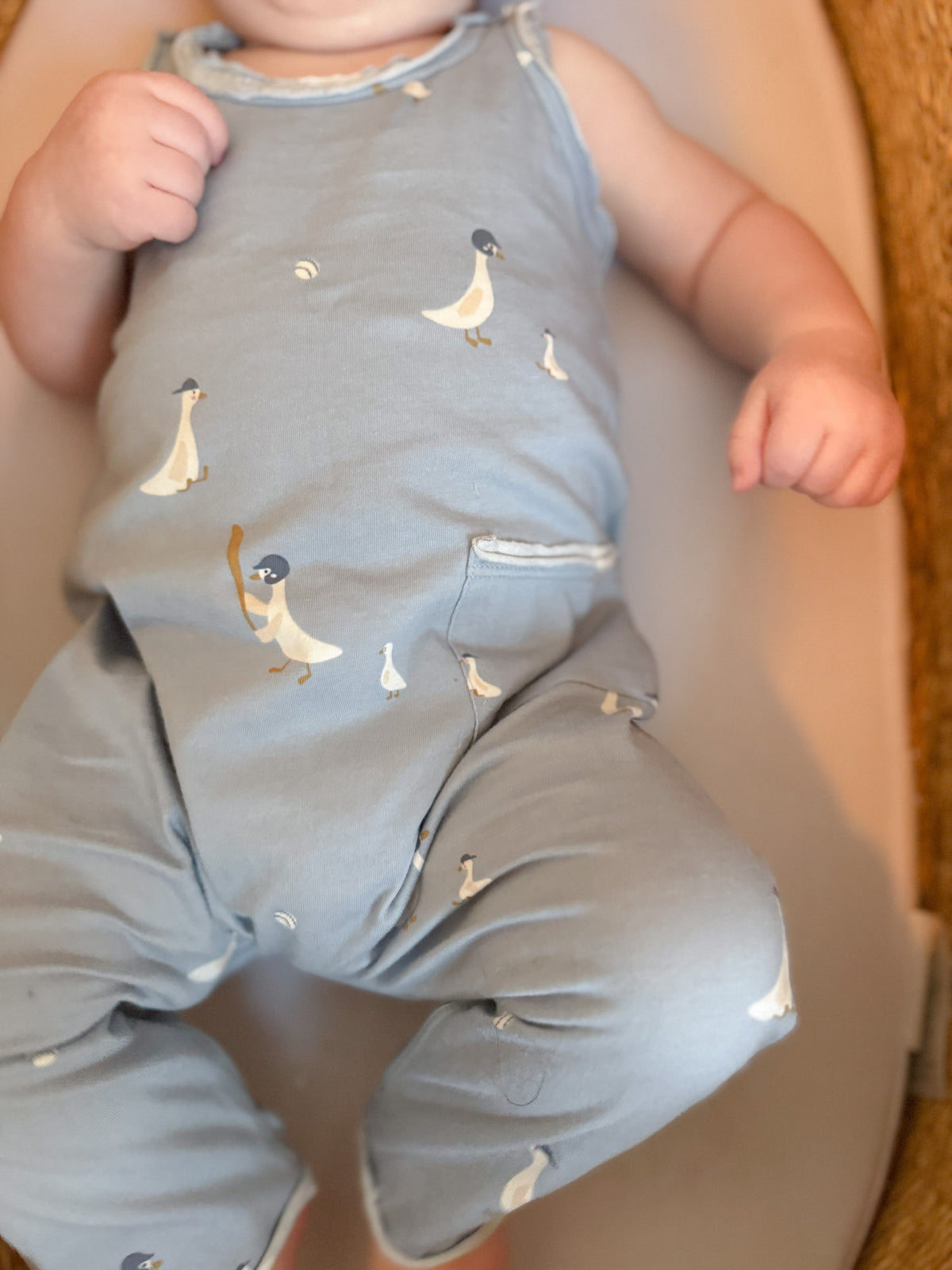 Light gray tank romper with allover goose print and front pocket