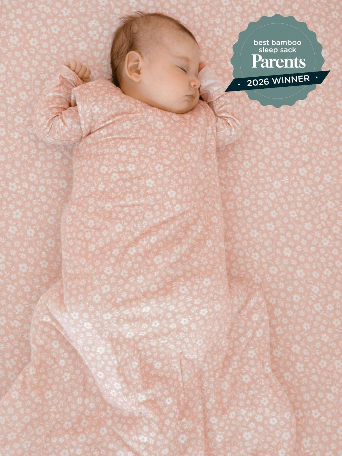 Light pink floral baby sleep sack with long sleeves, worn by a sleeping infant, 1.0 TOG.