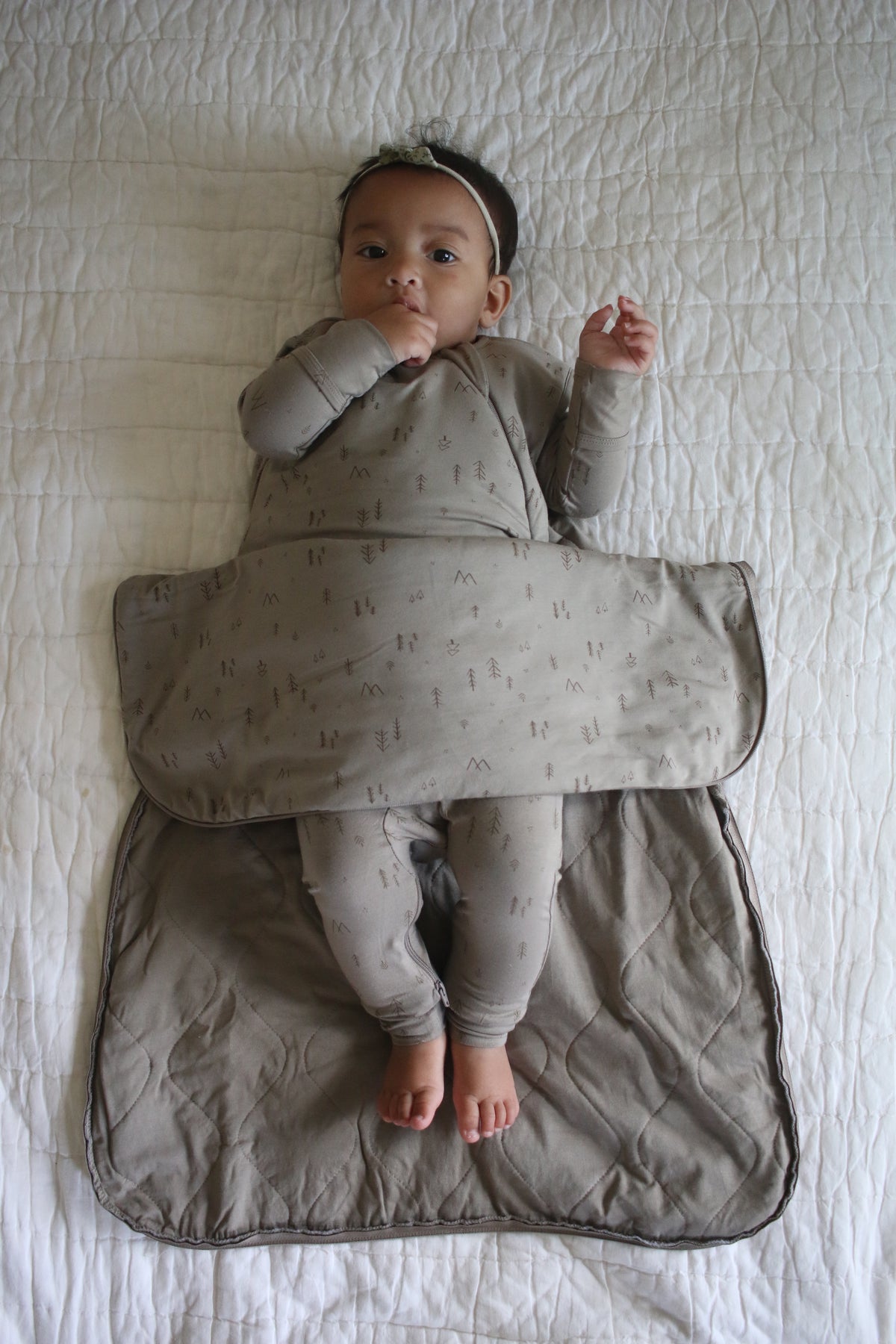 Light beige toddler sleep sack with tree print, front zip, and foot opening