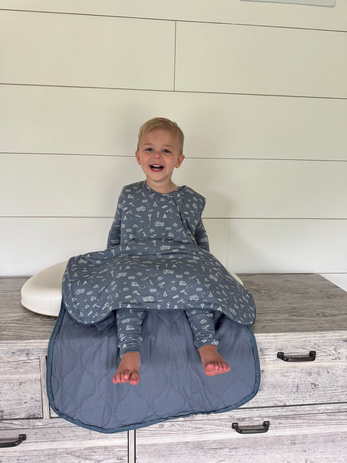 2.5 TOG infant sleep sack in dark blue with construction vehicle print, front zipper