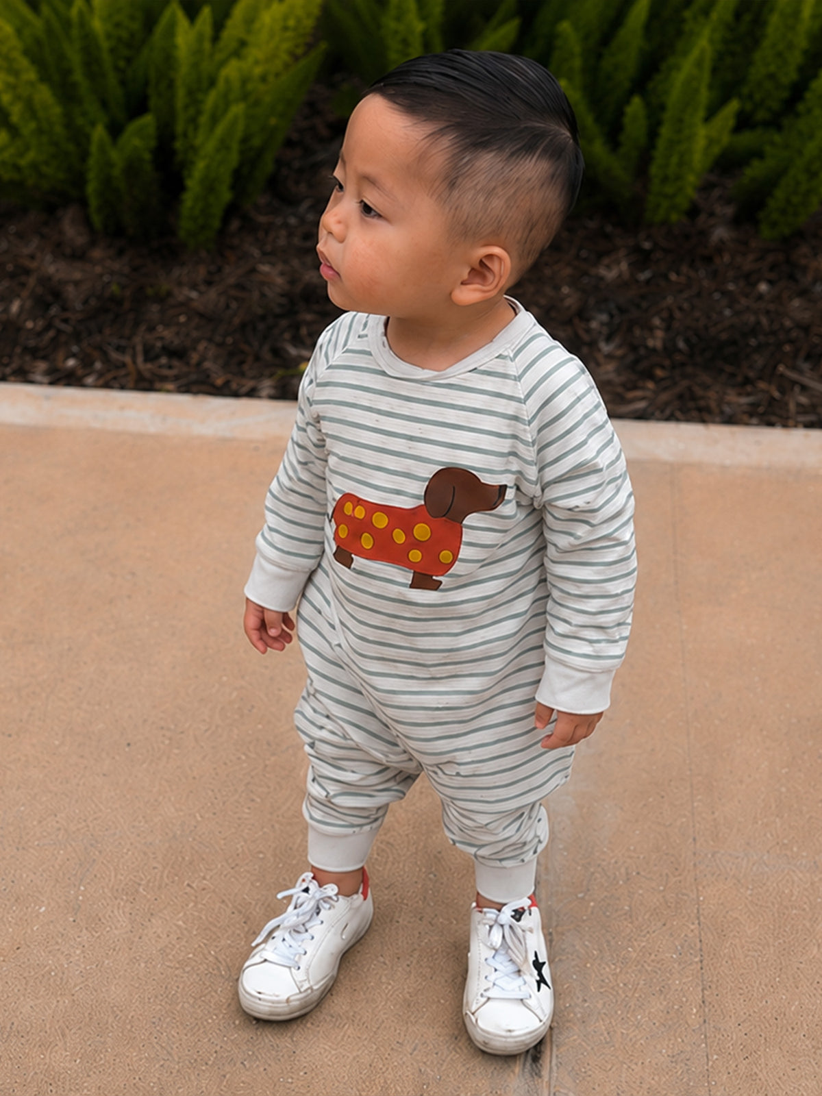 Gray-and-white striped fleece jumpsuit with dachshund graphic; front view