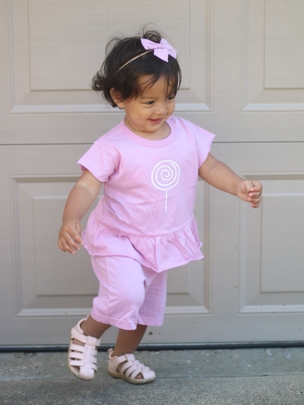 Lilac ruffled T-shirt and shorts set with lollipop graphic, toddler running outfit