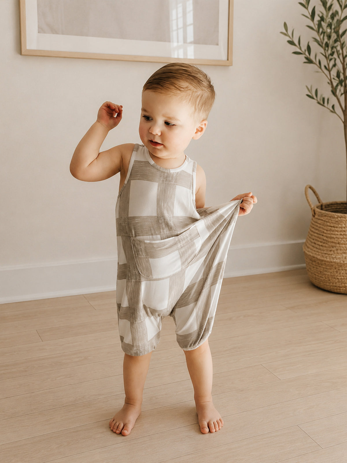 Sleeveless pocket romper with patchwork squares, light gray and white; standing