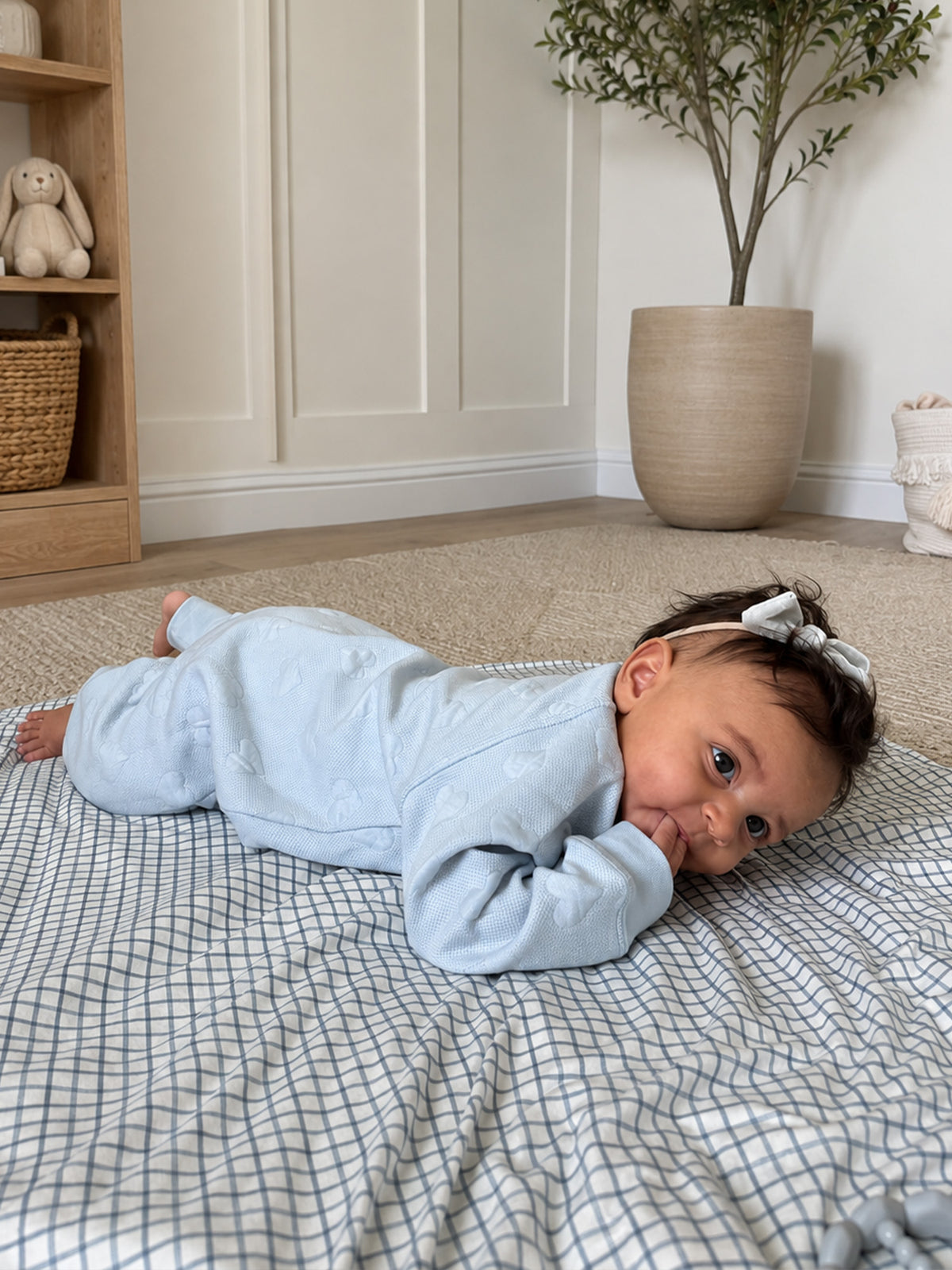 Light blue-gray baby jumpsuit with hood, long sleeves, and covered feet