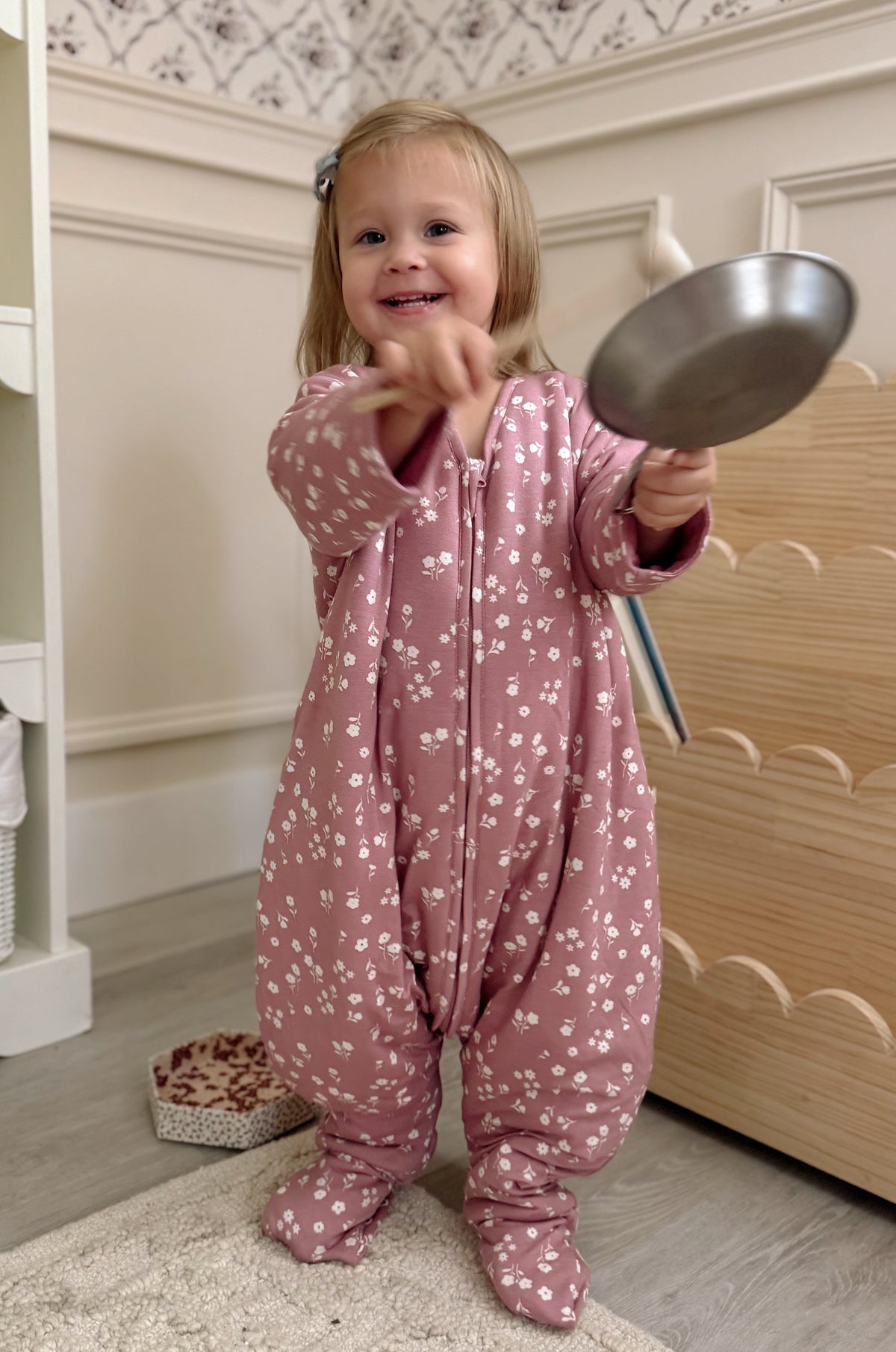 Dusty pink footie sleep sack with mini white floral print and full-length zip
