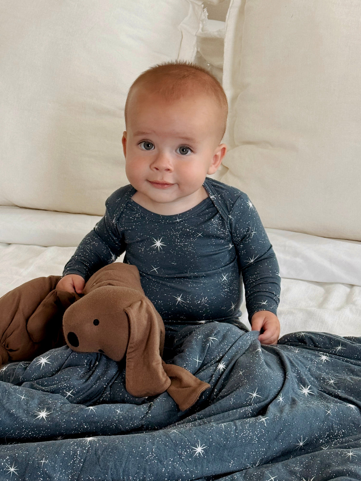 Infant convertible pajama in dark navy with white star pattern, long sleeves and legs