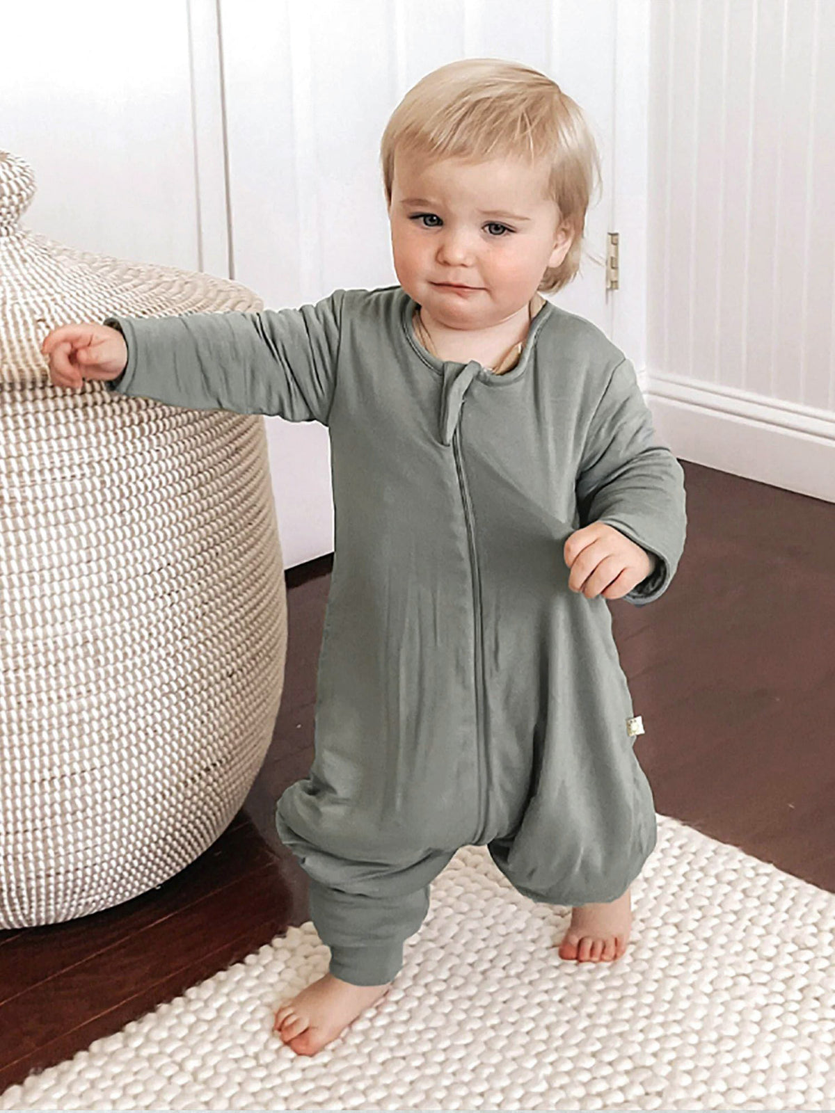 Sage green long-sleeve footie sleep sack with front zipper and open foot openings