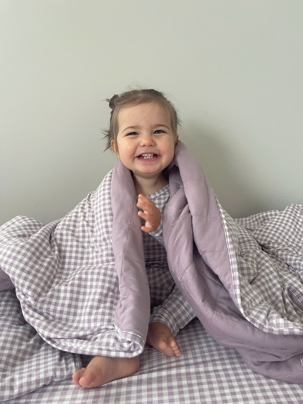 Hooded baby blanket with lilac hood and gray gingham outer, open front