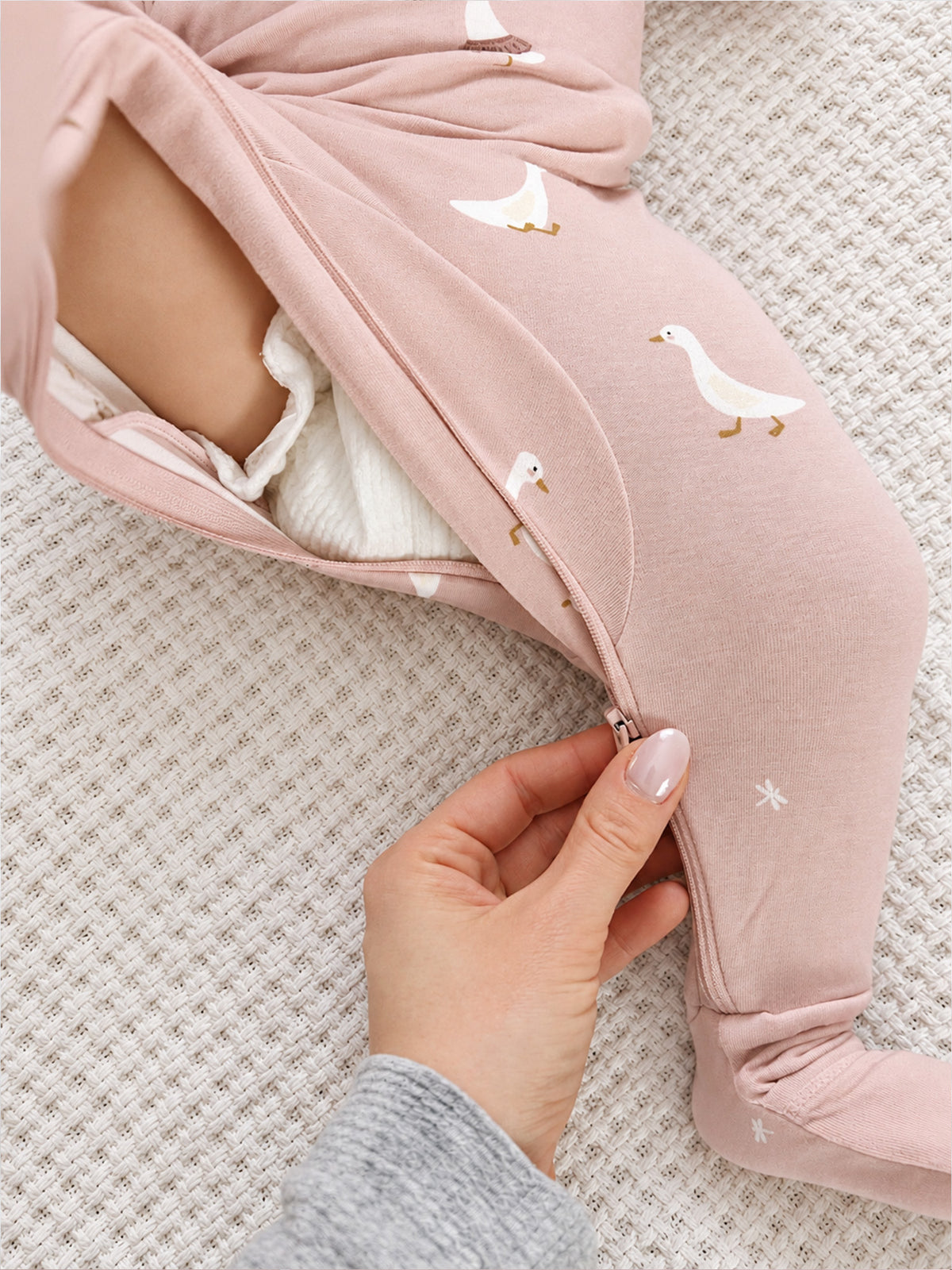 Pink convertible pajama with duck print, open fold showing inner lining