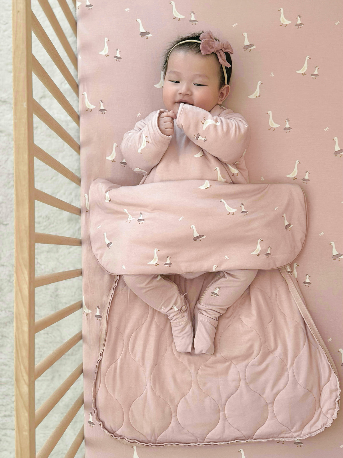 Blush pink swan-print long-sleeve sleep sack with quilted front