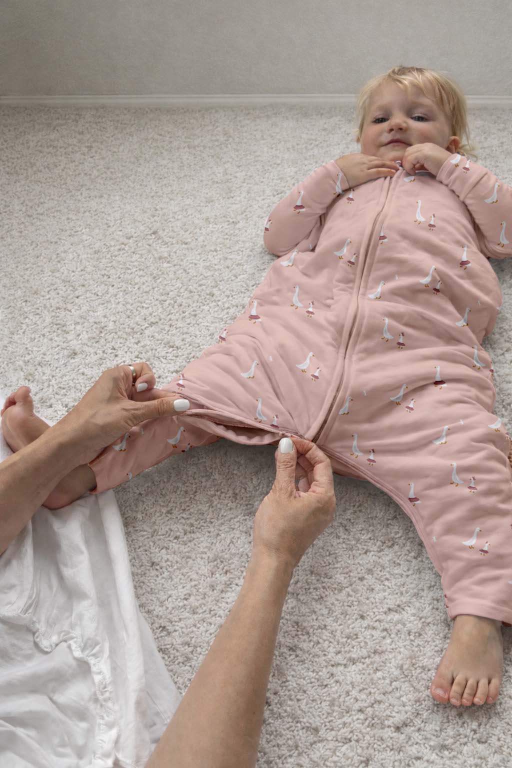 Pink duck-print footie sleep sack with front zipper and open foot section