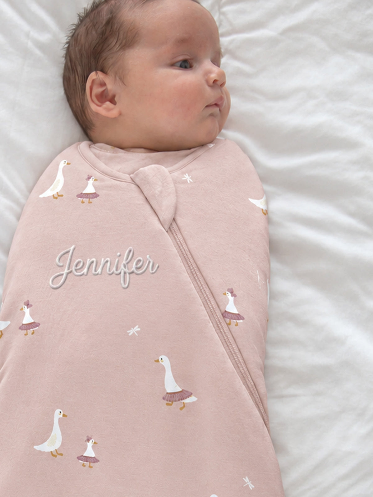 Pink swaddle sleep sack with scattered goose icons and front zip, 1.0 TOG