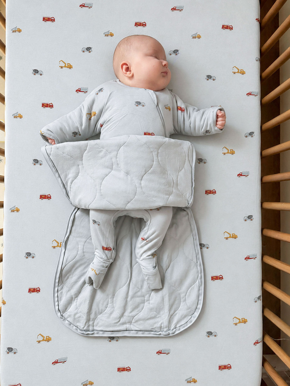 Long-sleeve swaddle sack with vehicle print, light gray, padded wrap shape