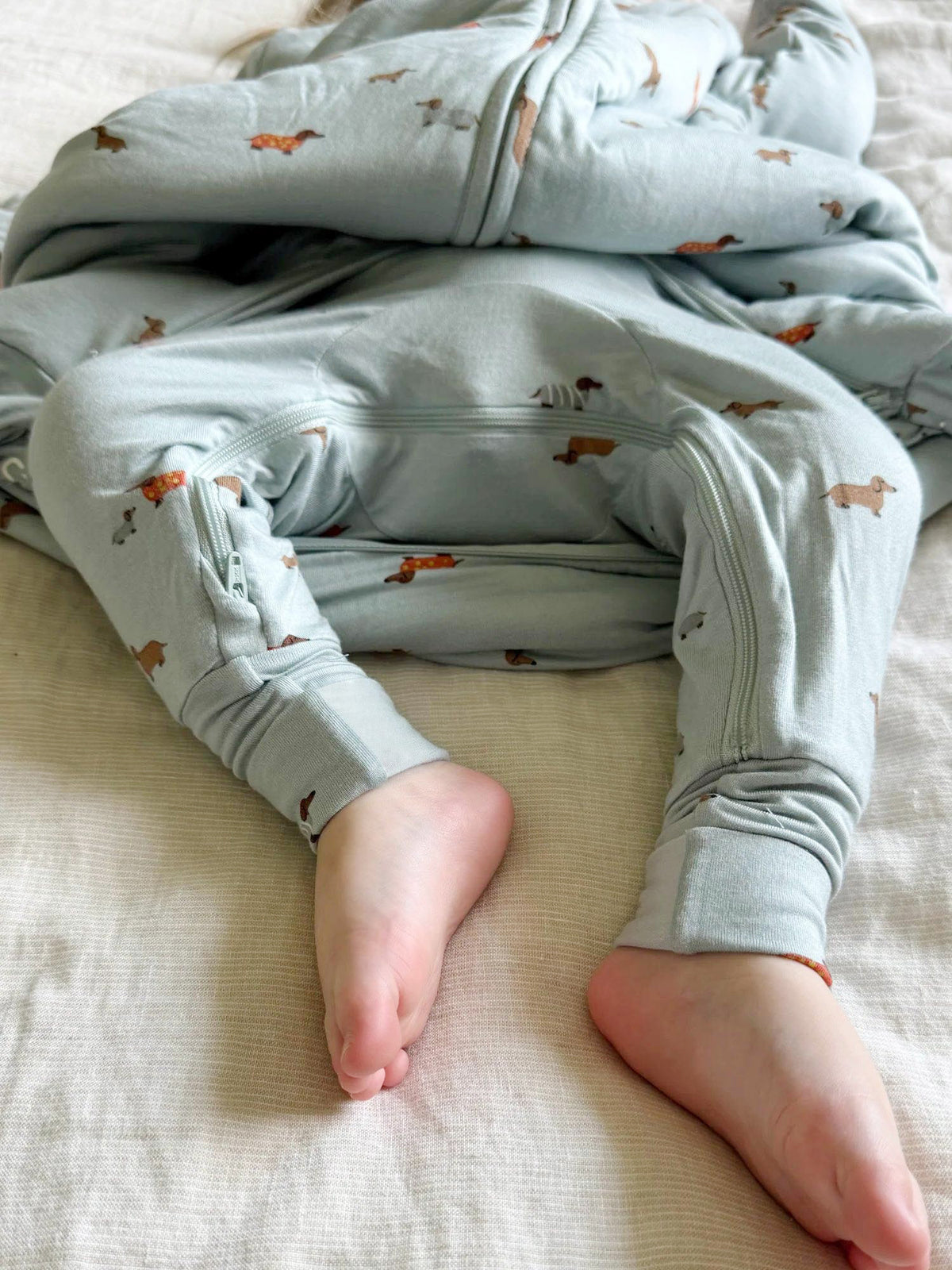 Long-sleeve footie sleep sack with dachshund print, folded view with covered feet