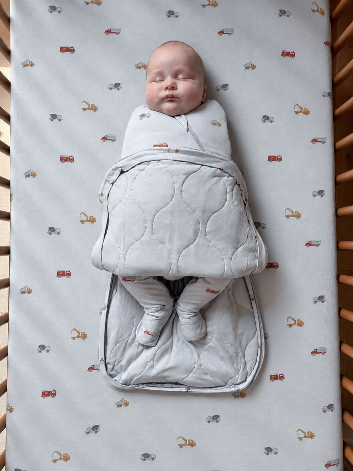 2.5 TOG sleep sack with gray quilted wings and multicolor vehicle pattern, zip front