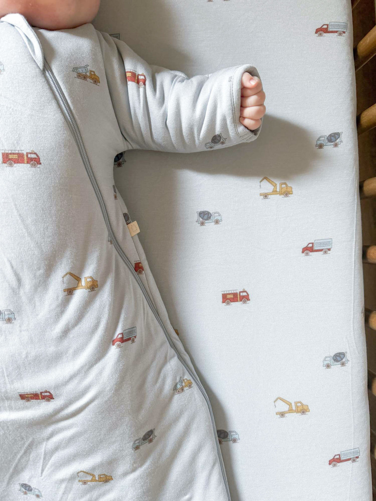 Long-sleeve swaddle sack with vehicle print, light gray; zippered opening