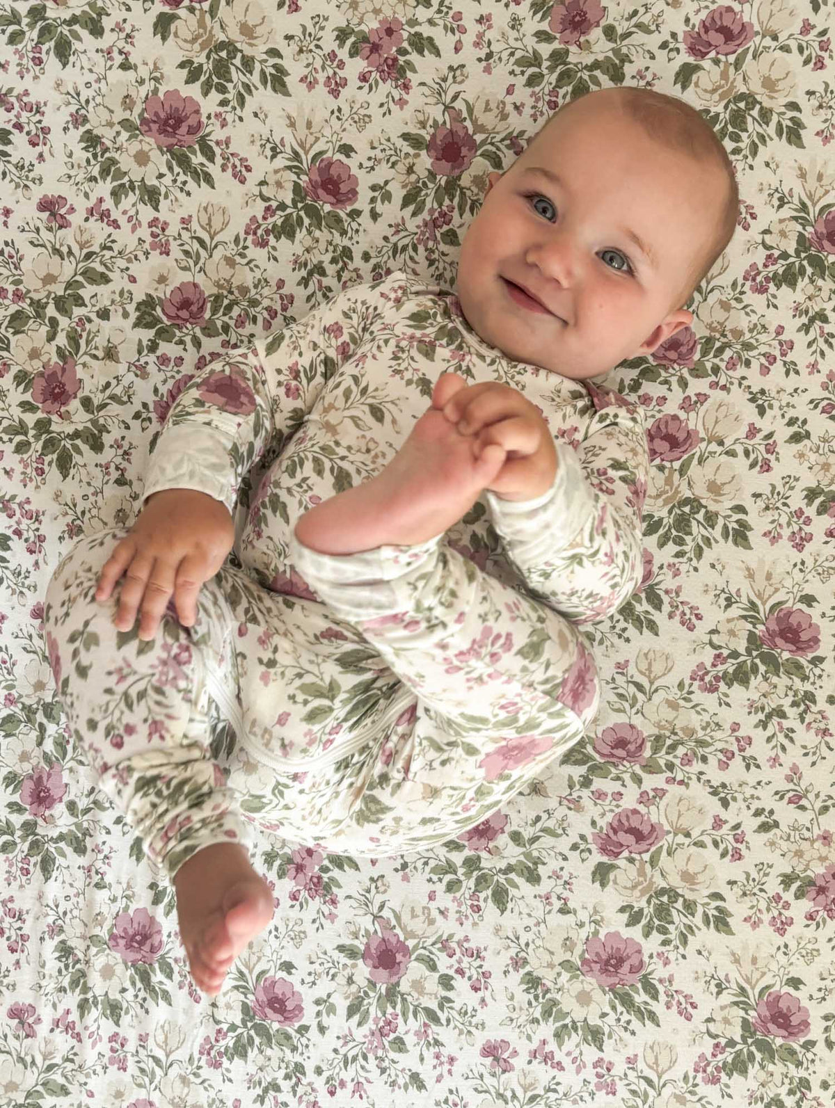 Floral convertible baby pajama one-piece with long sleeves and footed legs