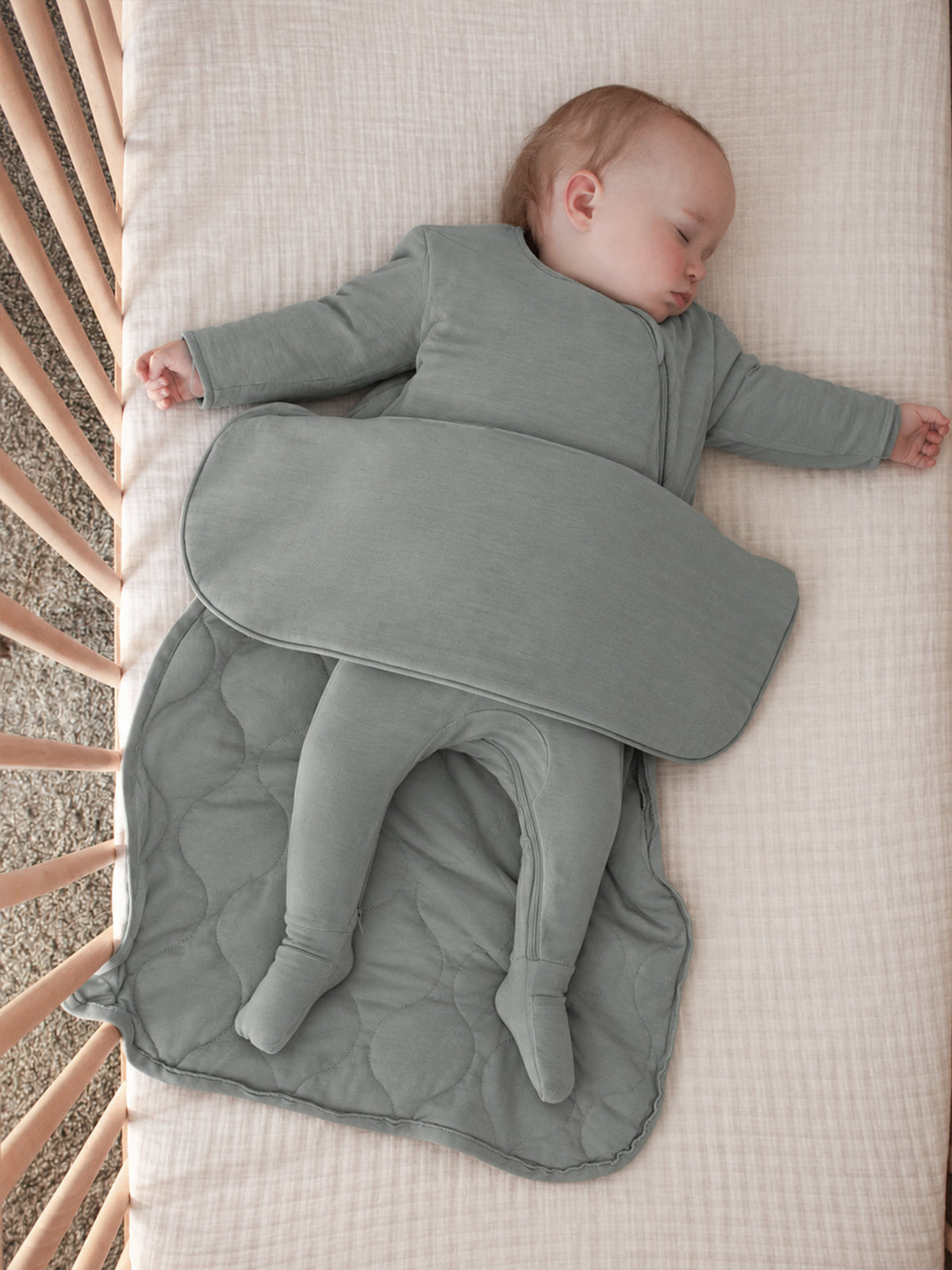 Sage green long-sleeve sleep sack with front zip and attached foot covers