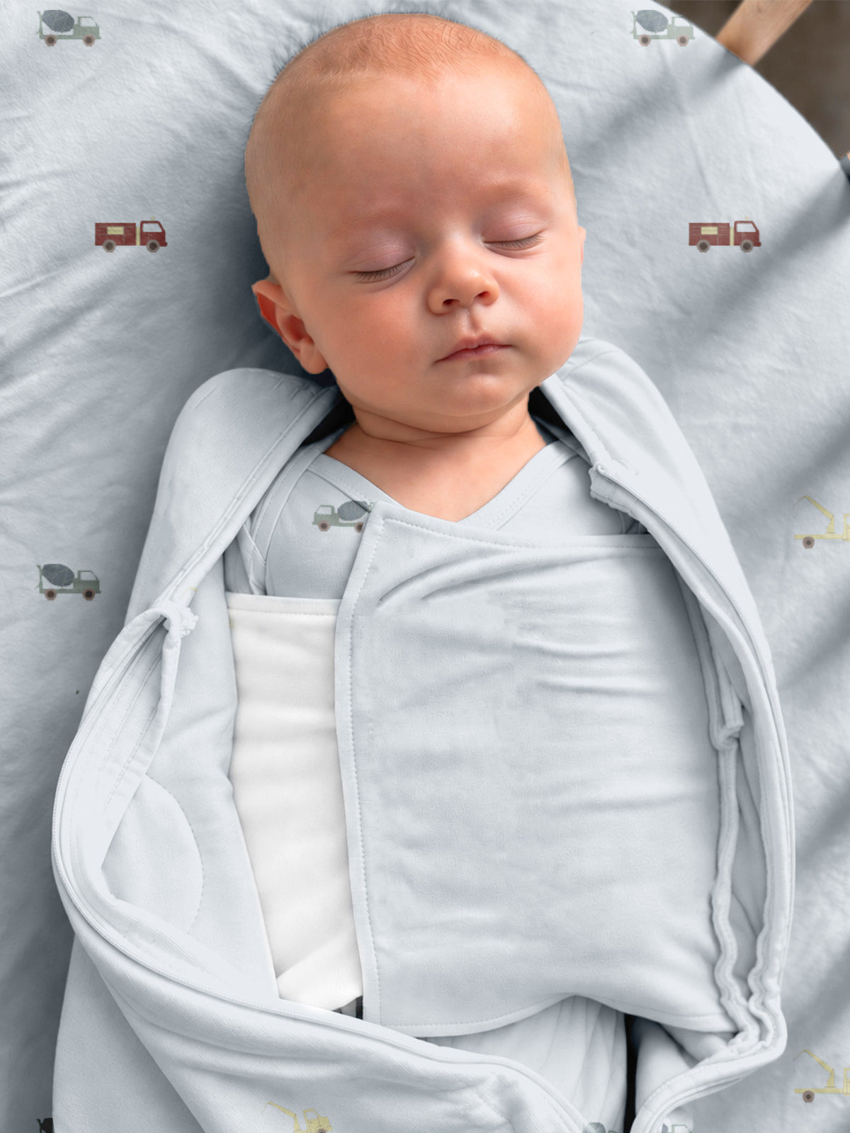 Light gray 2.5 TOG swaddle sleep sack with vehicle print and open front for baby