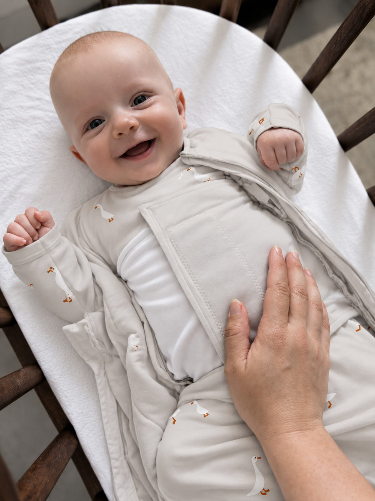 Cream long-sleeve swaddle sleep sack with goose print, zip-front wrap style