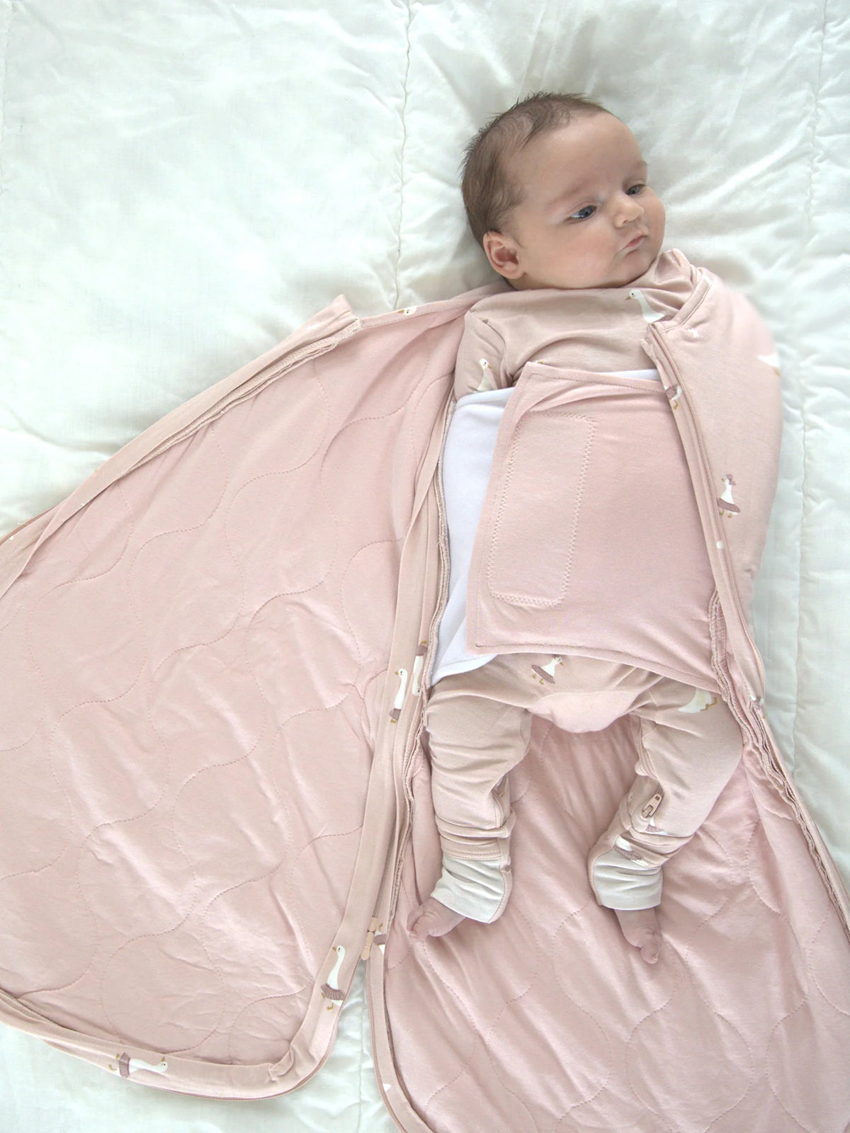 Pink swaddle sleep sack shown open with goose print and zip closure, 1.0 TOG