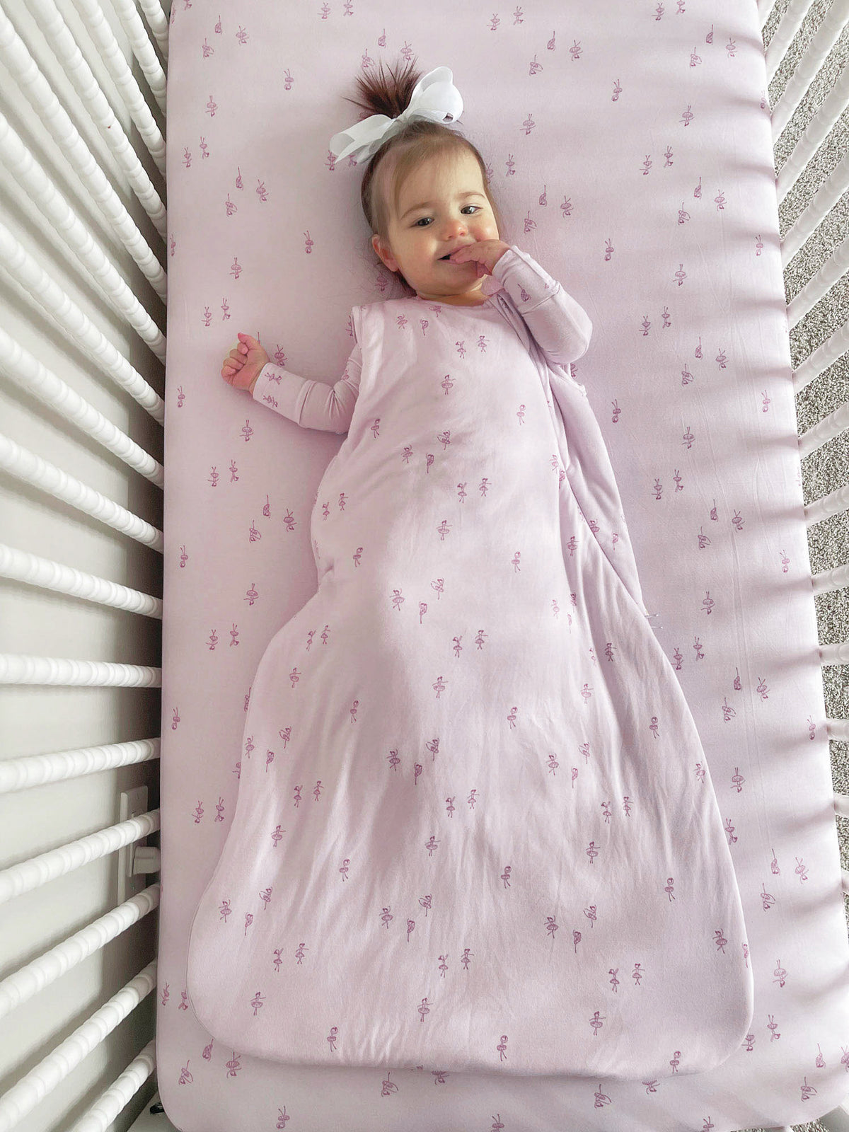 Baby sleep sack, light pink with small print, long wrap design and front opening