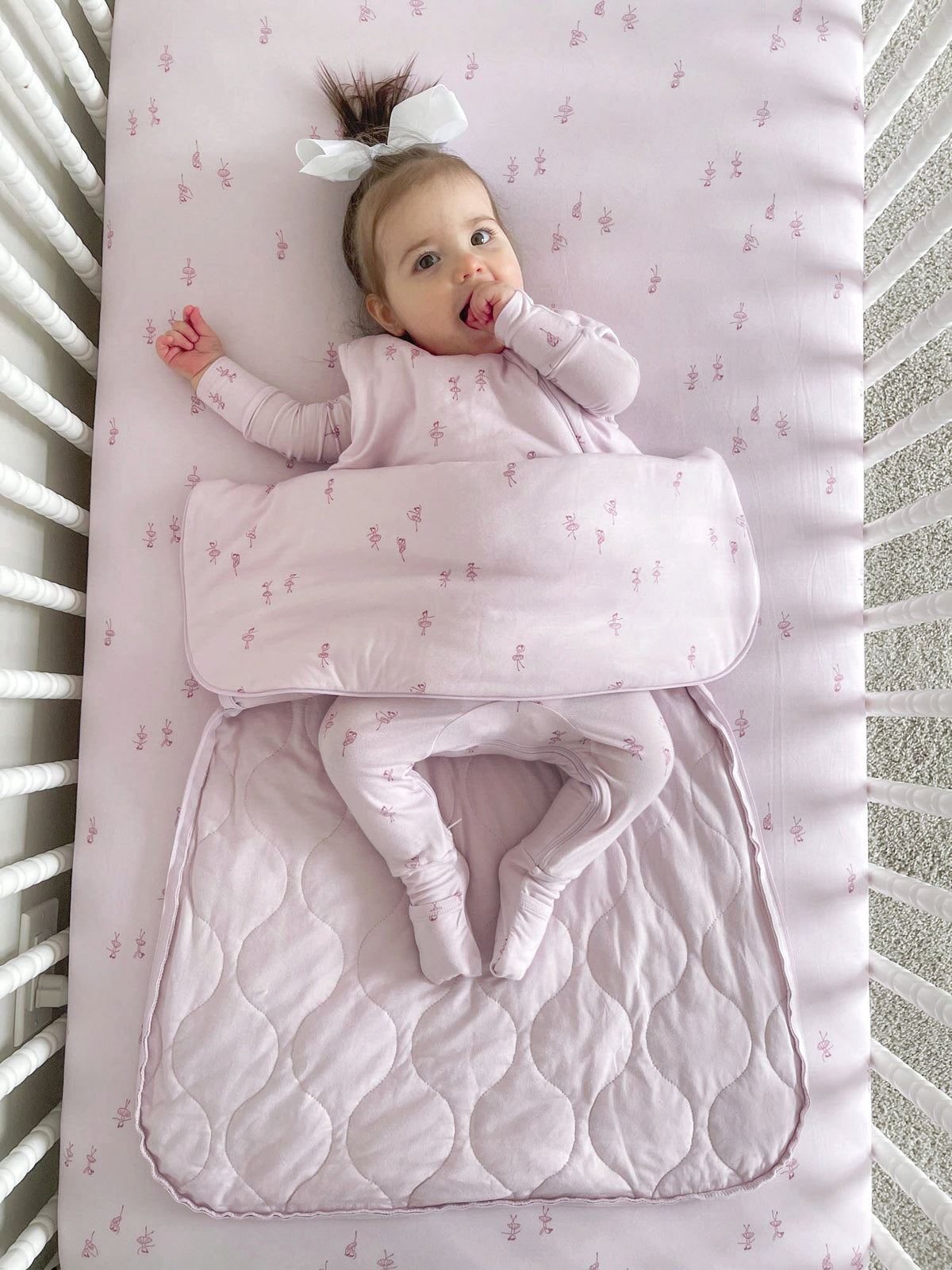 Baby sleep sack, light pink with small print, sleeveless arm holes and front opening