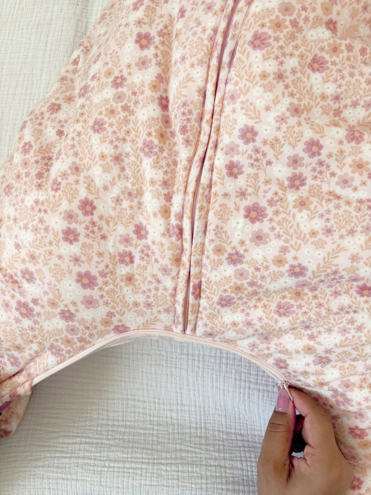 Floral footie sleep sack close-up with front zipper and soft fabric, gathered neckline