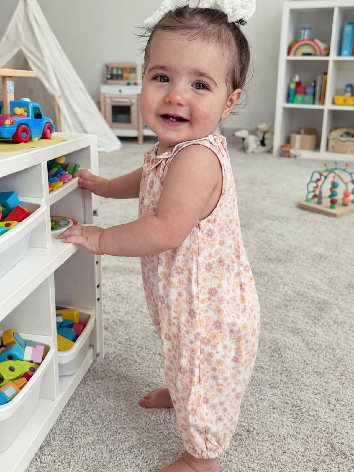 Floral bubble romper with ruffled collar, sleeveless peach-pink toddler one-piece