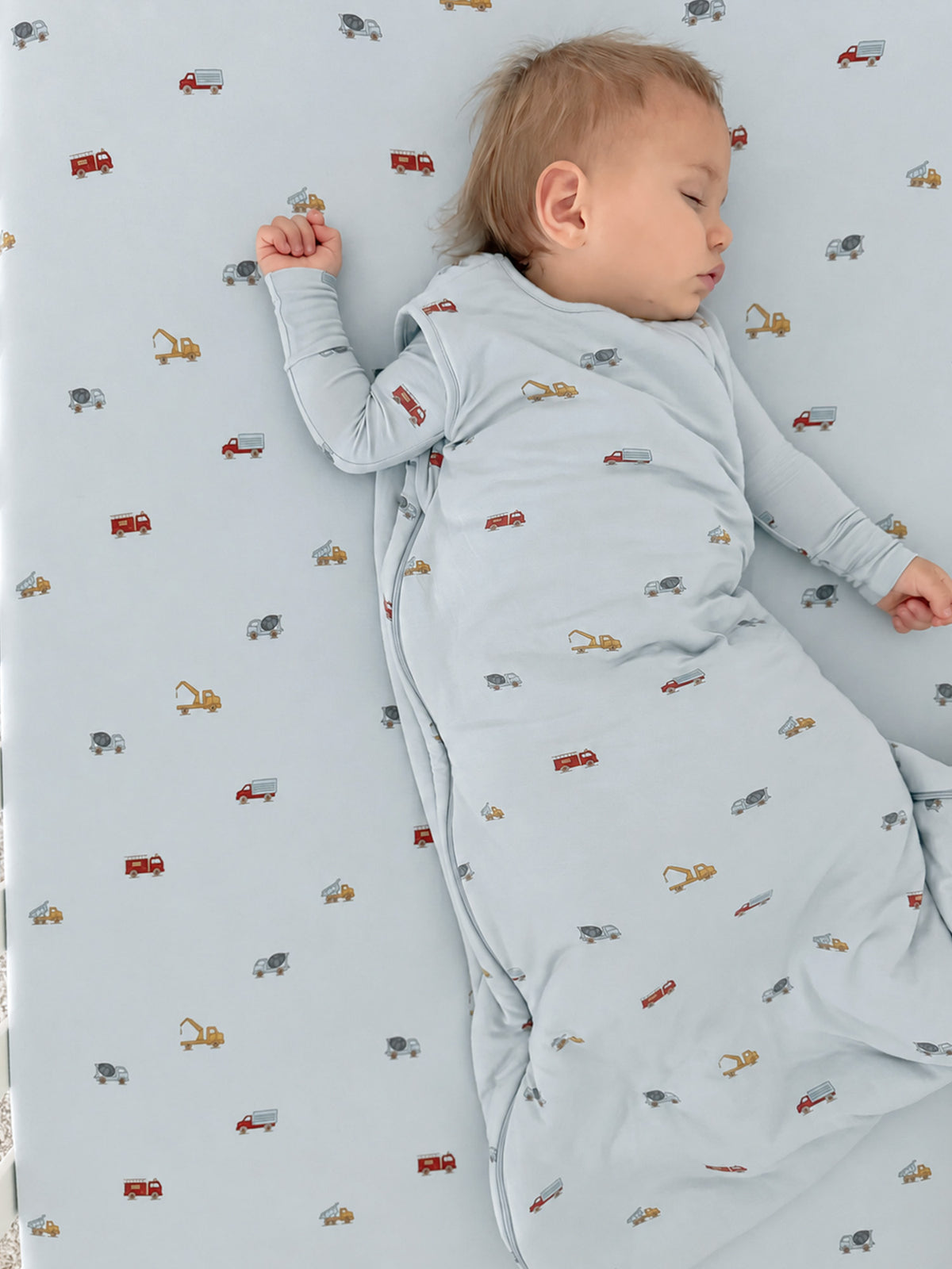 Light blue crib sheet with small cars and tools pattern