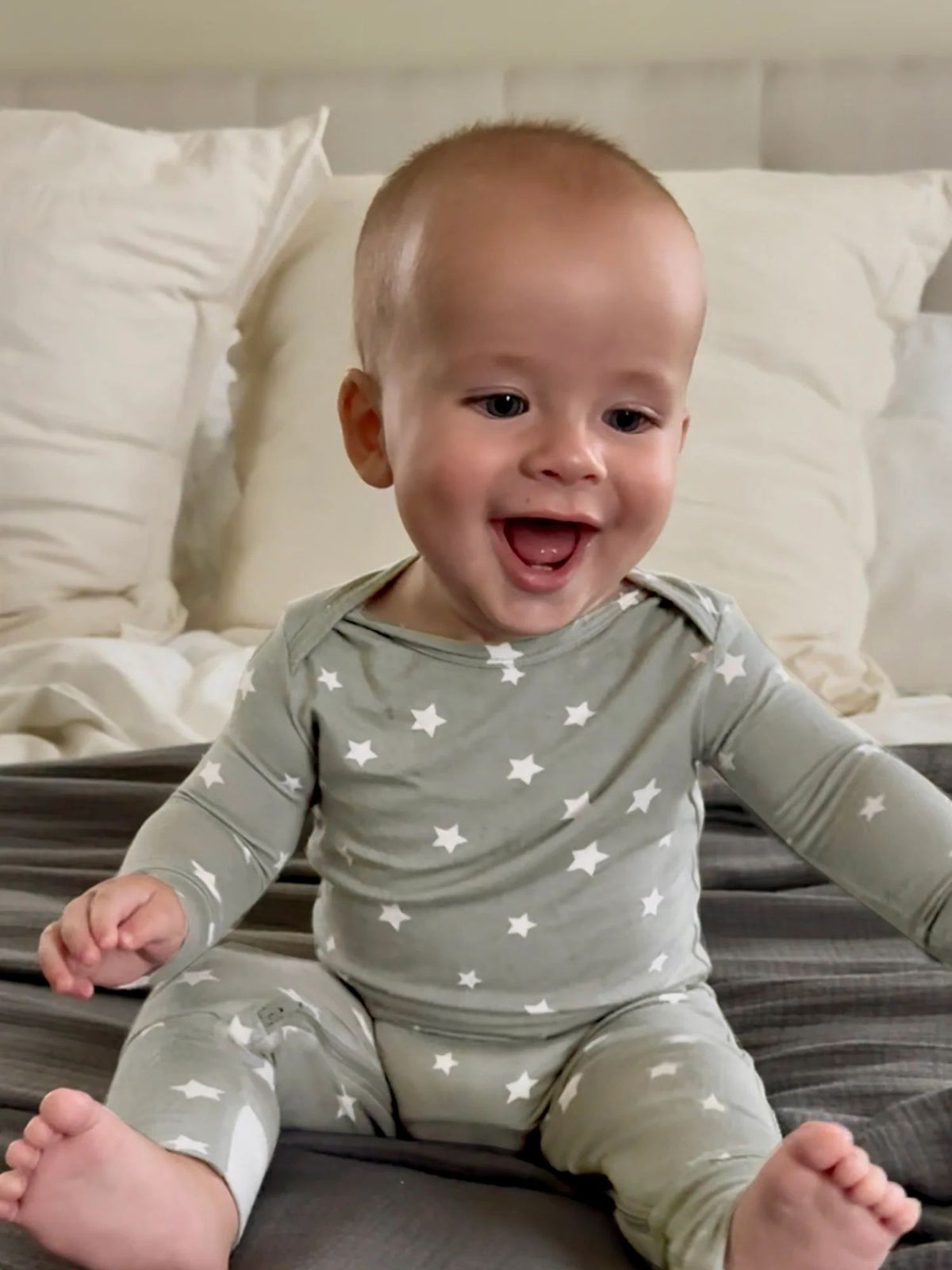 Sage green baby romper with long sleeves and white star print