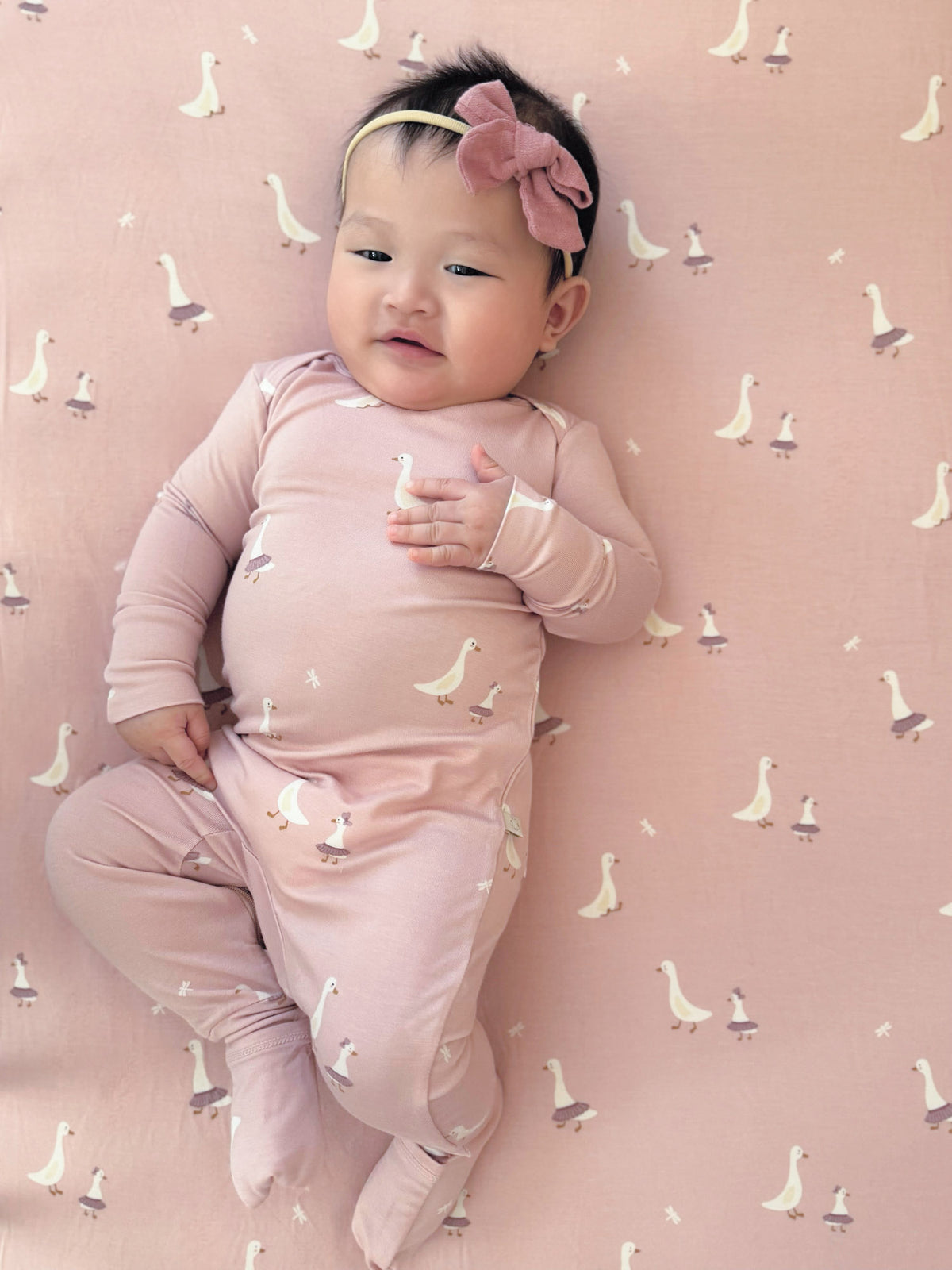 Pink long-sleeve convertible pajama set with duck print and enclosed feet