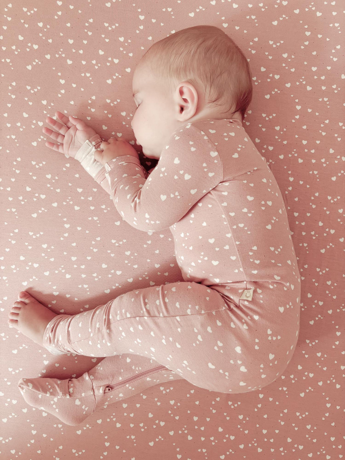 Mauve heart-print baby pajama romper, long sleeves and covered hands