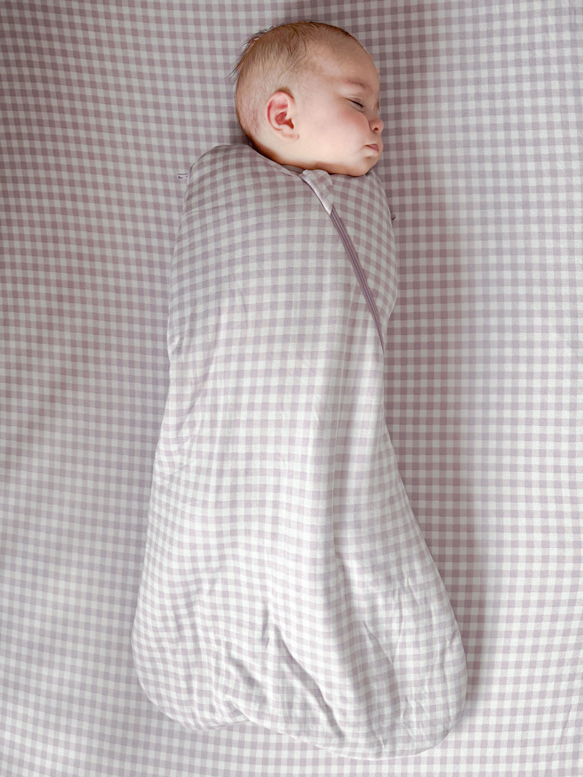 Lavender check swaddle sleep sack with hooded opening and secure wrap