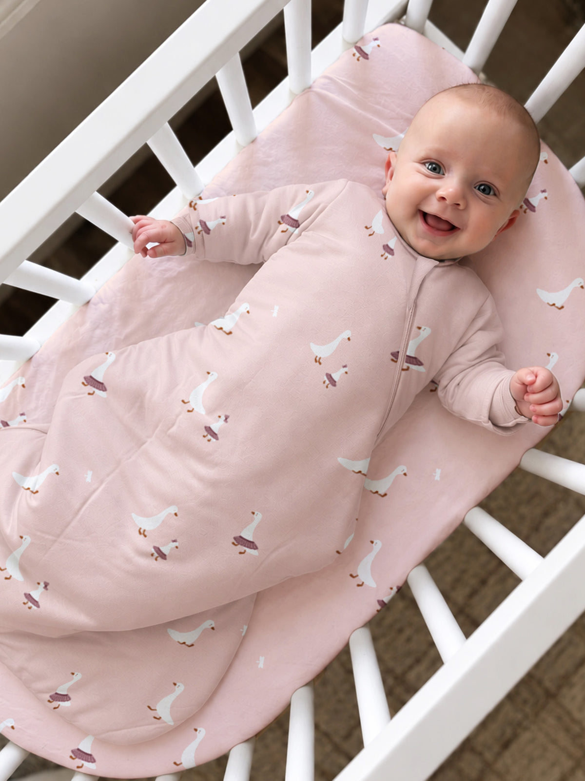 Pink long-sleeve sleep sack with duck print, front zipper and footed design