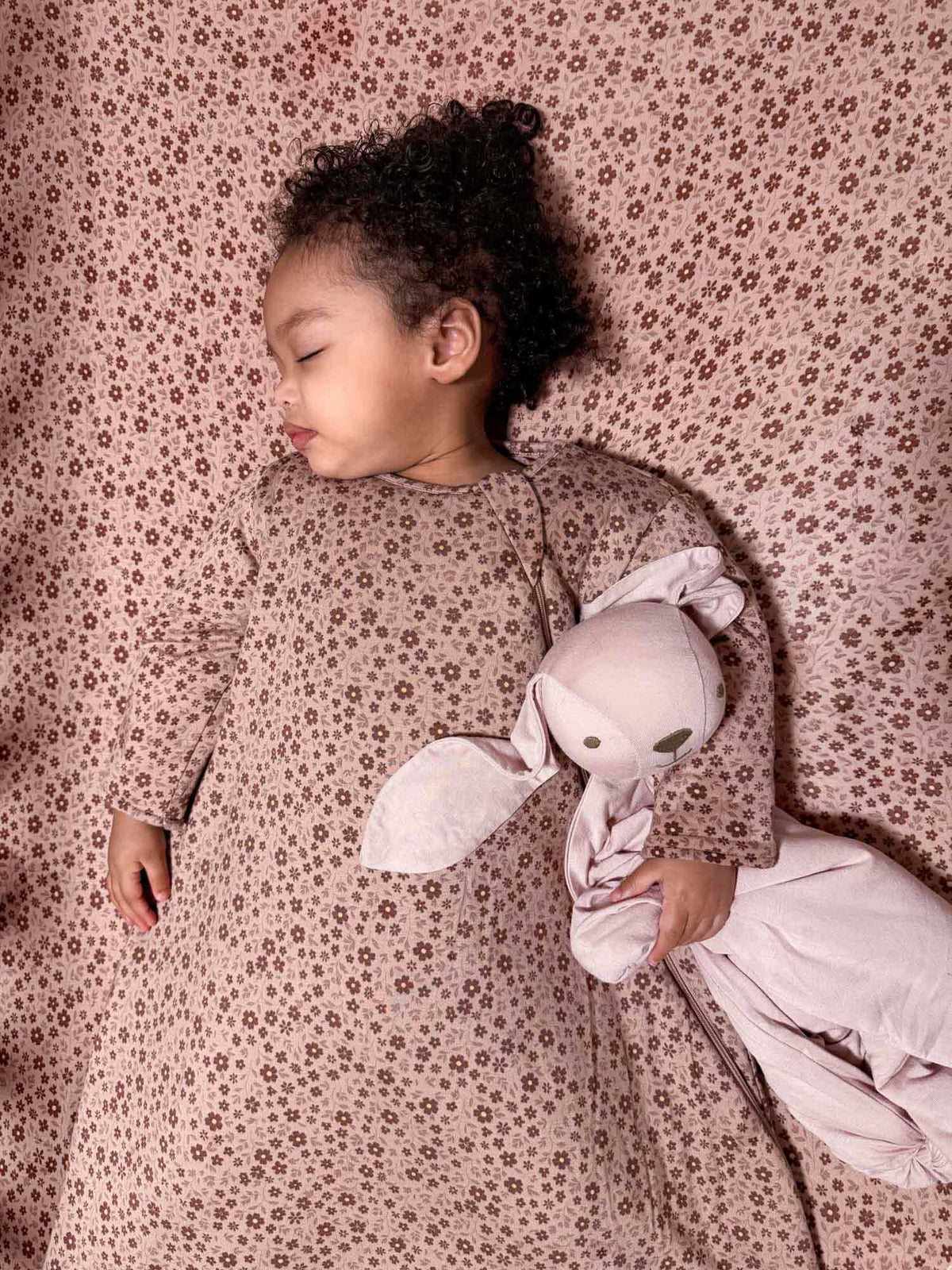 Light pink floral long-sleeve sleep sack with petal print, front view